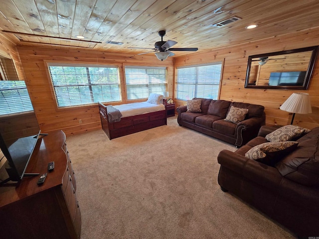 carpeted living room featuring a wealth of natural light, wood walls, and wood ceiling