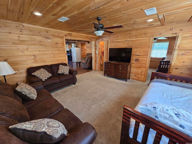 bedroom featuring ceiling fan, wooden walls, carpet, and wooden ceiling