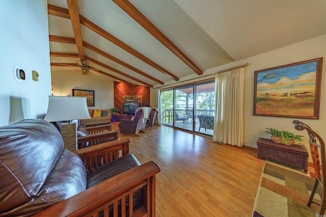 living room featuring wood-type flooring, lofted ceiling with beams, and ceiling fan