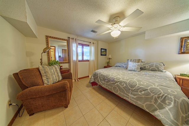 bedroom featuring light tile patterned floors, a textured ceiling, and ceiling fan