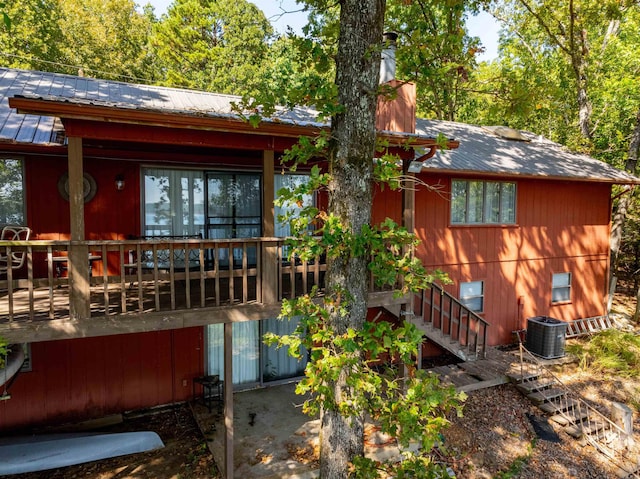 back of property featuring a wooden deck and central AC