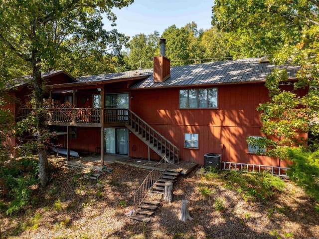 back of property with a wooden deck and central AC unit