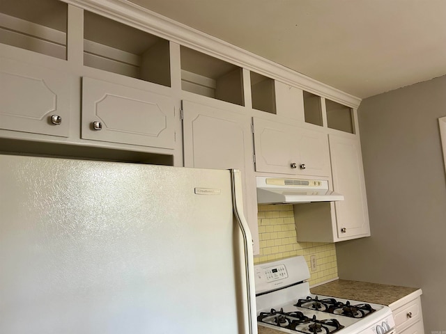 kitchen with decorative backsplash, white appliances, and white cabinets