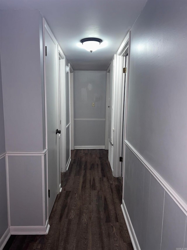 corridor with dark wood-type flooring