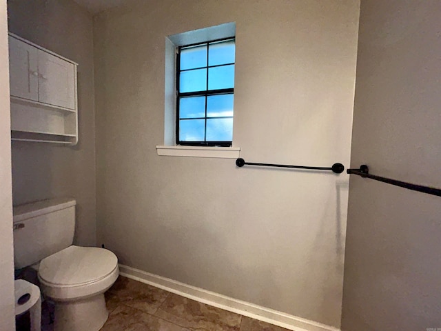 bathroom with tile patterned flooring and toilet