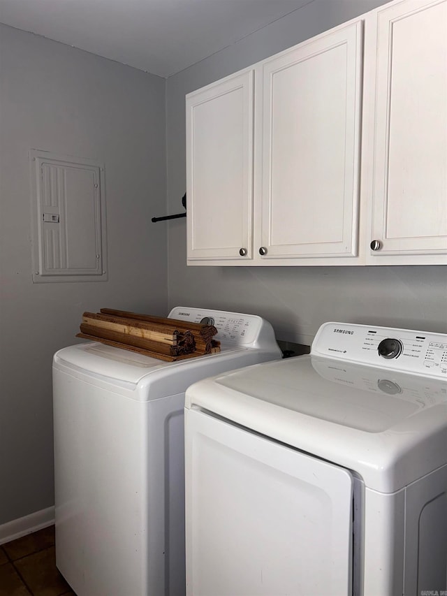 clothes washing area with cabinets, separate washer and dryer, electric panel, and dark tile patterned flooring