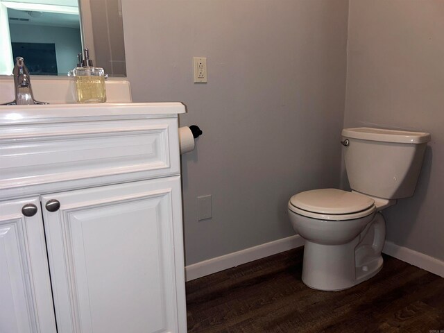 bathroom featuring hardwood / wood-style floors, vanity, and toilet