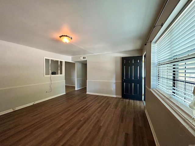 empty room with dark wood-type flooring