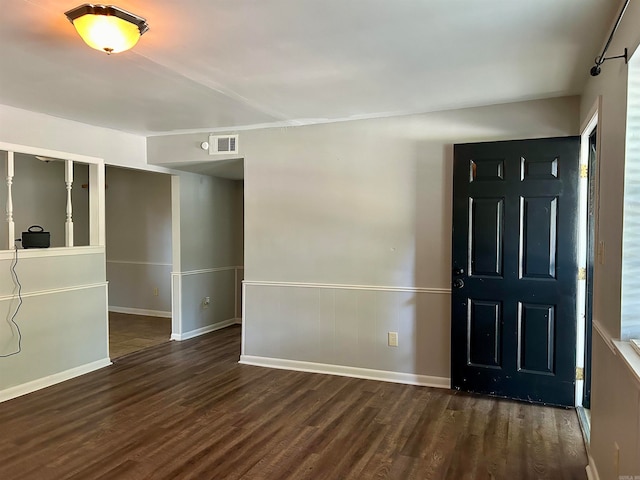 entryway with dark hardwood / wood-style flooring