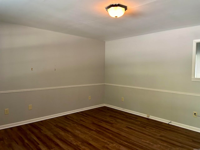 empty room with dark hardwood / wood-style floors