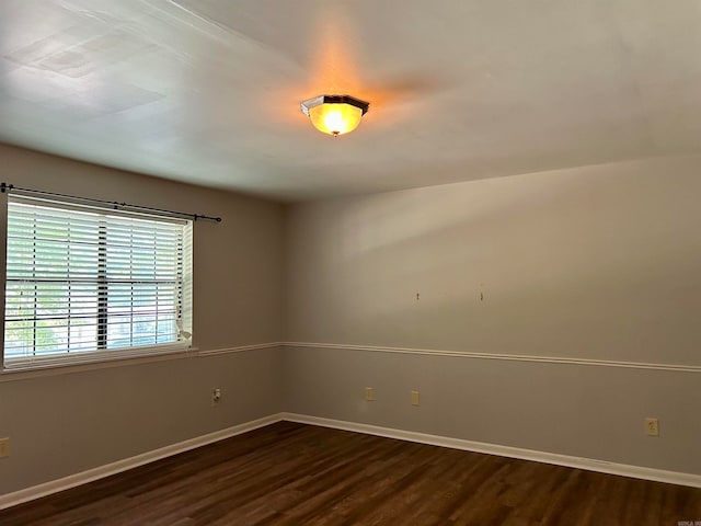 unfurnished room featuring dark hardwood / wood-style flooring