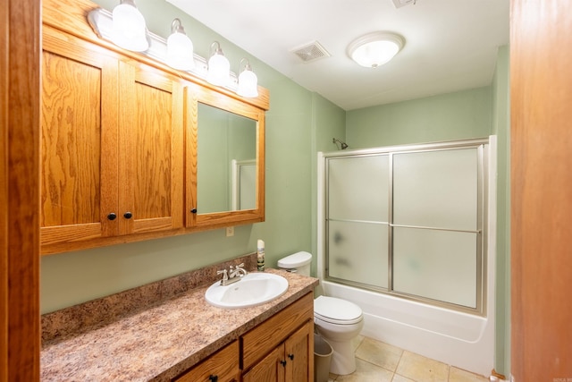 full bathroom featuring enclosed tub / shower combo, tile patterned floors, vanity, and toilet