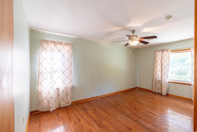 empty room featuring hardwood / wood-style flooring and ceiling fan