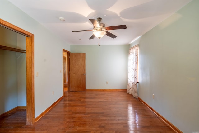 unfurnished bedroom with ceiling fan, a closet, and dark hardwood / wood-style flooring