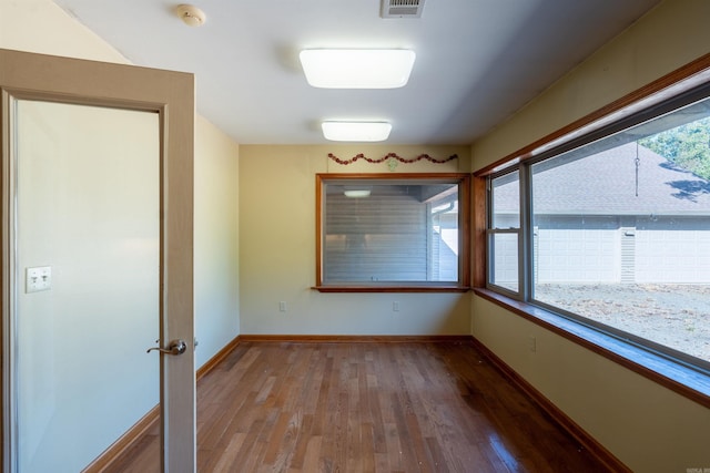 interior space with wood-type flooring and a healthy amount of sunlight