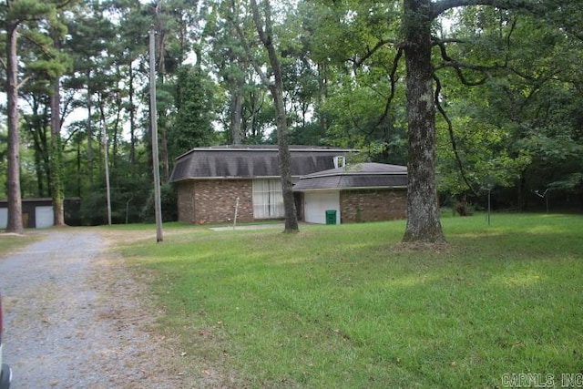 view of front of property with a front yard and a garage