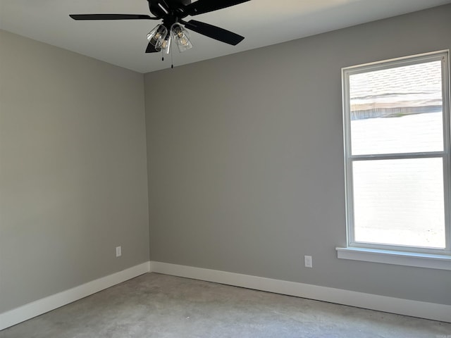 spare room featuring a healthy amount of sunlight and ceiling fan