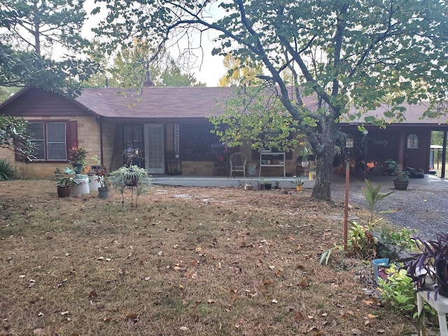 back of house featuring a shingled roof