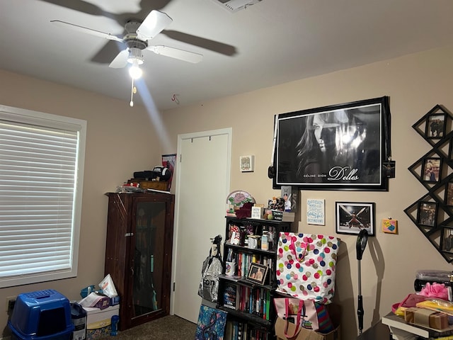 interior space featuring carpet floors and ceiling fan