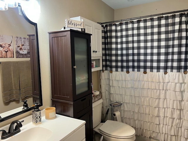 bathroom featuring vanity, toilet, and a shower with shower curtain