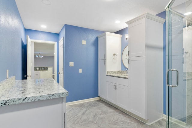 bathroom featuring walk in shower and vanity