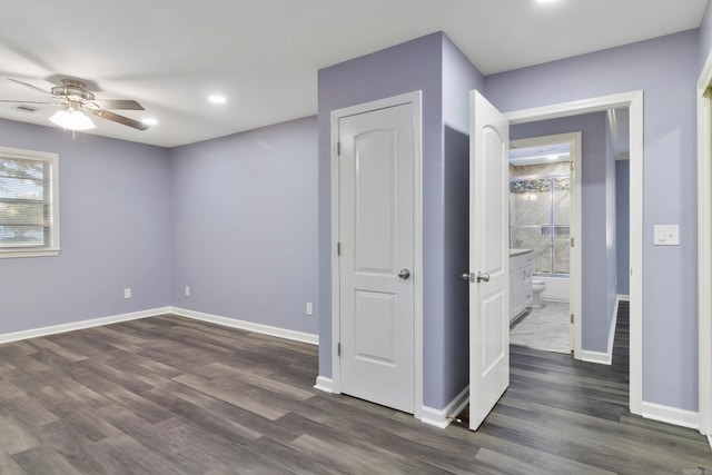 empty room with dark hardwood / wood-style floors and ceiling fan