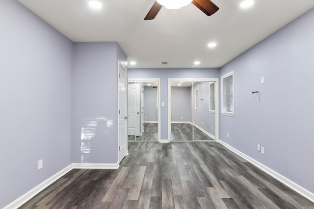 spare room featuring ceiling fan and dark wood-type flooring