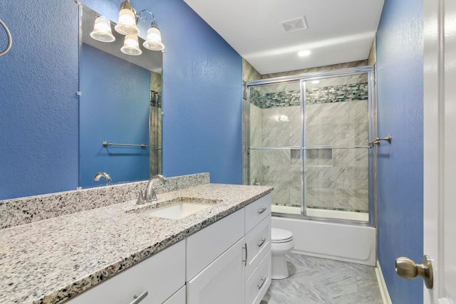 full bathroom featuring shower / bath combination with glass door, vanity, and toilet