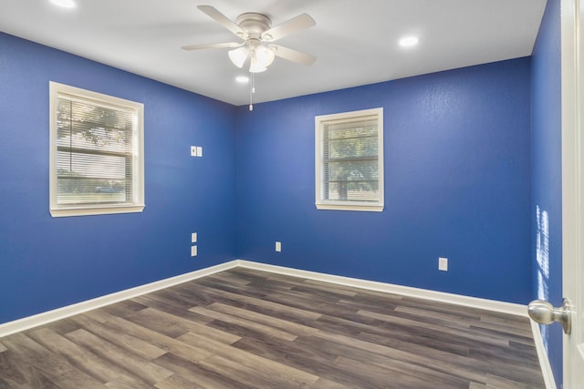 empty room featuring ceiling fan and dark wood-type flooring