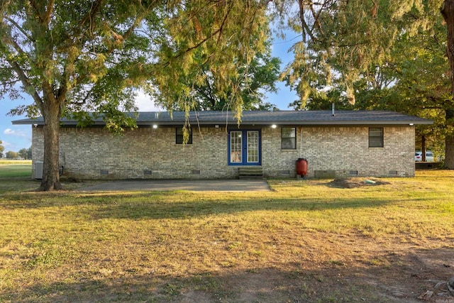 rear view of property featuring a yard