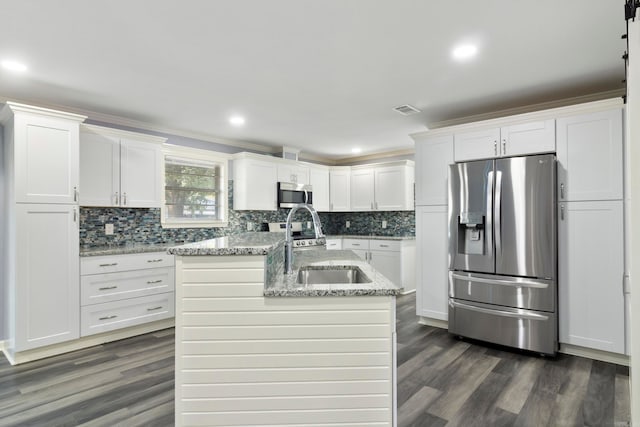 kitchen with a kitchen island with sink, sink, stainless steel appliances, dark hardwood / wood-style floors, and white cabinets