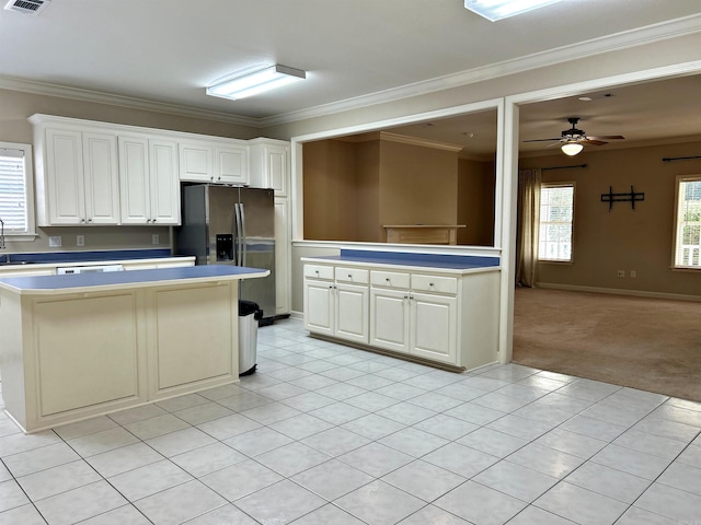 kitchen featuring a wealth of natural light, white cabinets, and light colored carpet