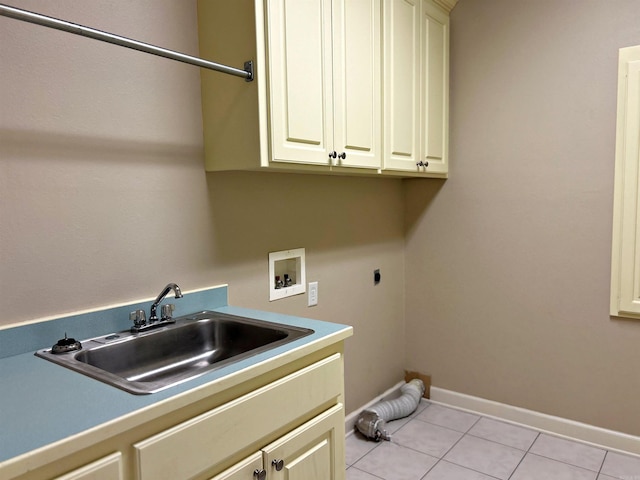 laundry room featuring washer hookup, light tile patterned flooring, sink, hookup for an electric dryer, and cabinets