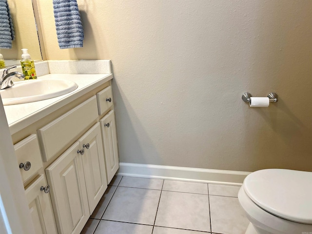 bathroom with tile patterned floors, vanity, and toilet