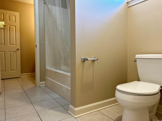 bathroom with tile patterned flooring, shower / tub combo with curtain, and toilet