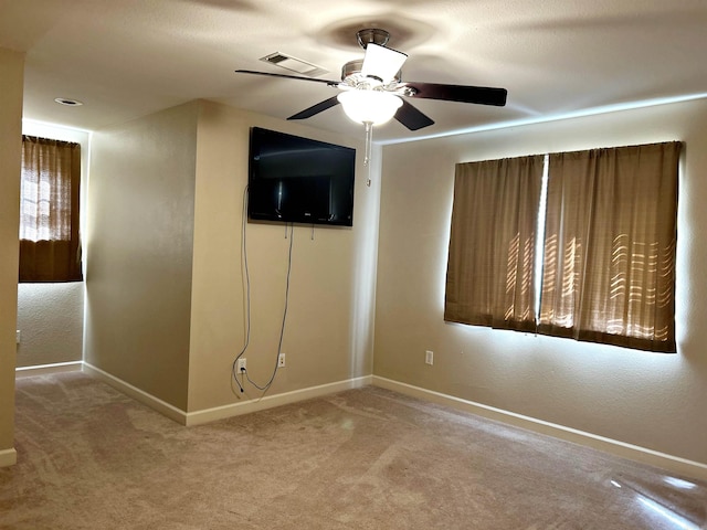 interior space with ceiling fan and light carpet