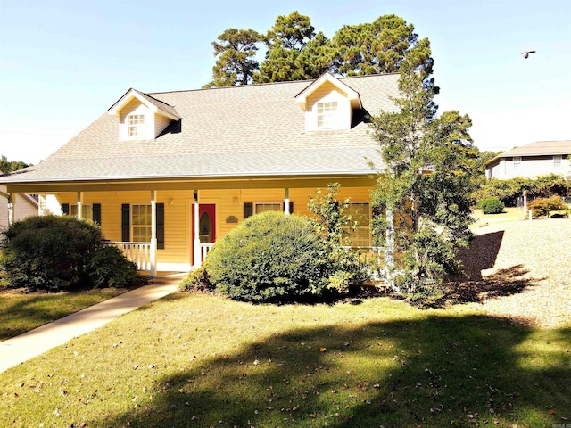 view of front of property with covered porch and a front yard