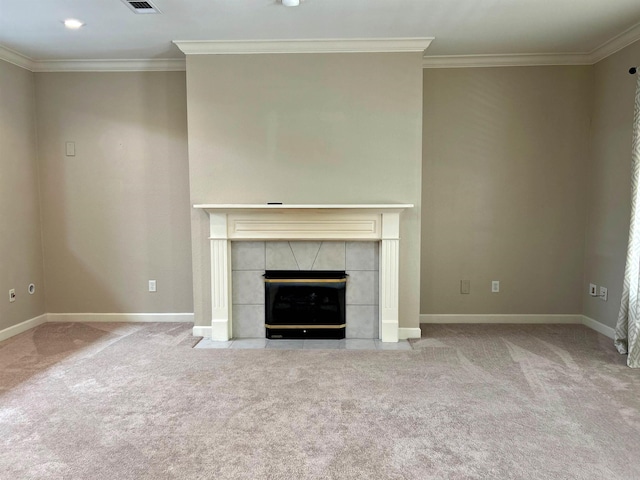 unfurnished living room with ornamental molding, light colored carpet, and a tiled fireplace