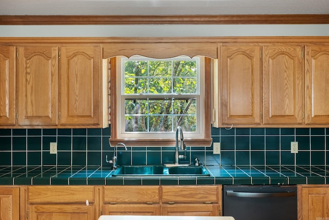 kitchen featuring tile counters, decorative backsplash, dishwashing machine, and sink