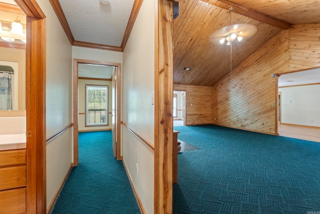 bonus room featuring dark colored carpet, wood ceiling, vaulted ceiling, and wooden walls