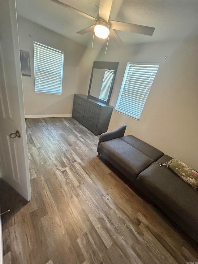 unfurnished living room featuring ceiling fan and wood-type flooring