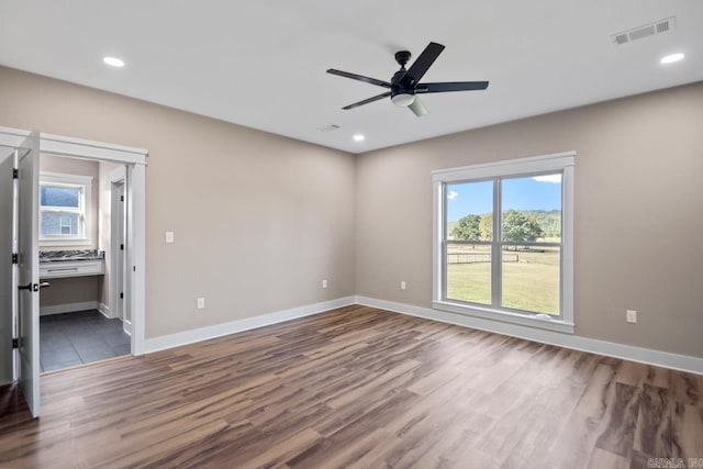 empty room featuring ceiling fan and dark wood-type flooring