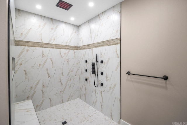 bathroom with a tile shower