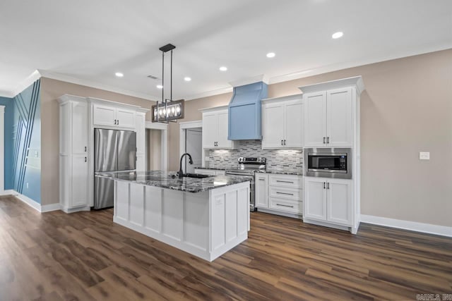 kitchen featuring appliances with stainless steel finishes, a kitchen island with sink, white cabinets, and dark hardwood / wood-style flooring