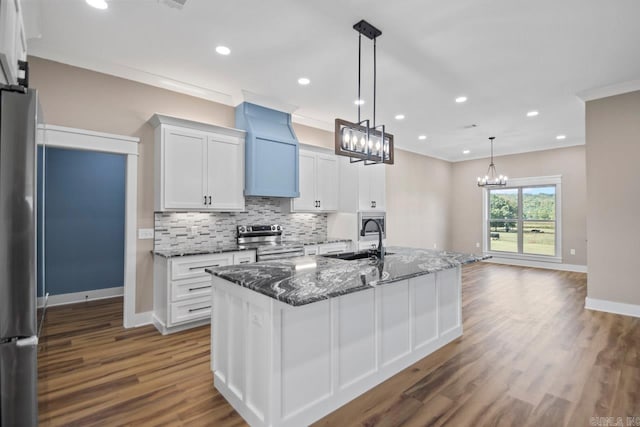 kitchen with dark hardwood / wood-style flooring, sink, an island with sink, appliances with stainless steel finishes, and white cabinetry