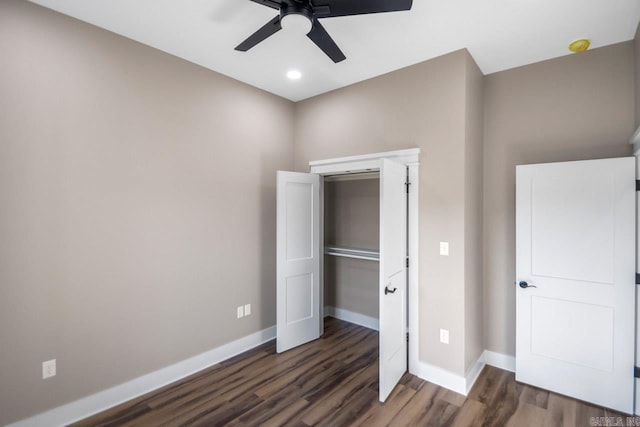 unfurnished bedroom featuring ceiling fan, dark wood-type flooring, and a closet