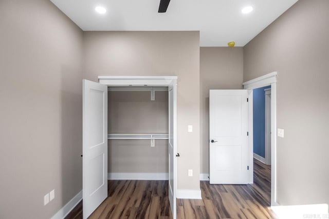 unfurnished bedroom featuring ceiling fan, a closet, and dark hardwood / wood-style floors