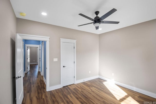 unfurnished bedroom with dark hardwood / wood-style floors and ceiling fan