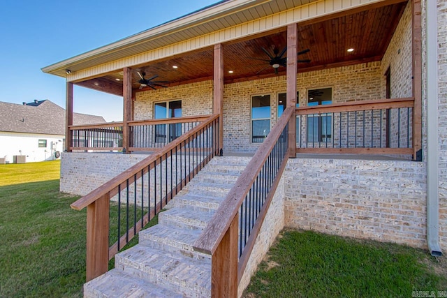 wooden deck with a yard and ceiling fan