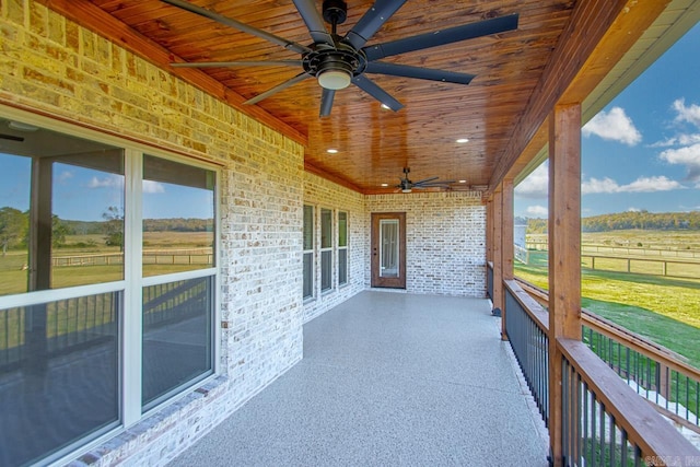 view of patio featuring ceiling fan and a rural view